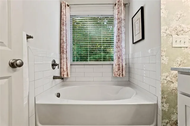 a bathroom with a sink a mirror and a shower