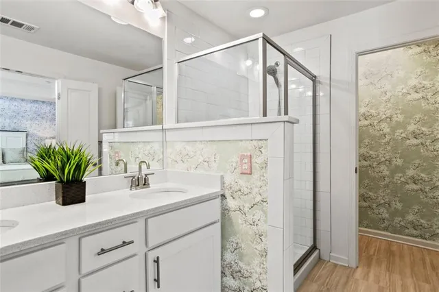 a bathroom with a shower and a sink