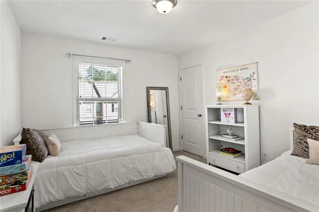 a bedroom with a bed and a couch