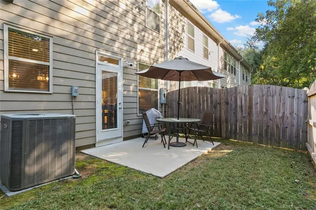 a view of a backyard with wooden fence