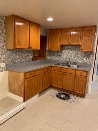 a kitchen with a sink and cabinets