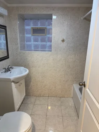 a white toilet sitting next to a bathroom sink