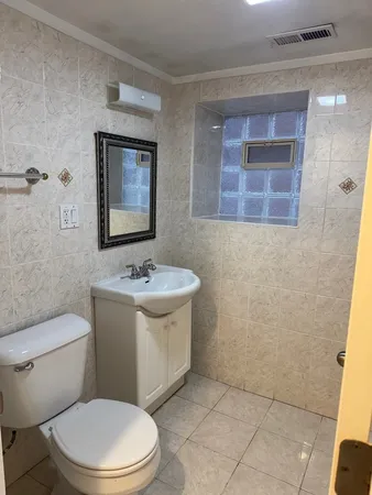 a white toilet sitting next to a bathroom sink