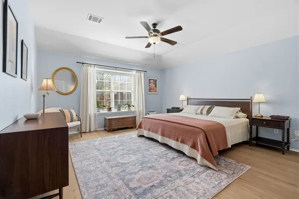 a spacious bedroom with a bed and a window