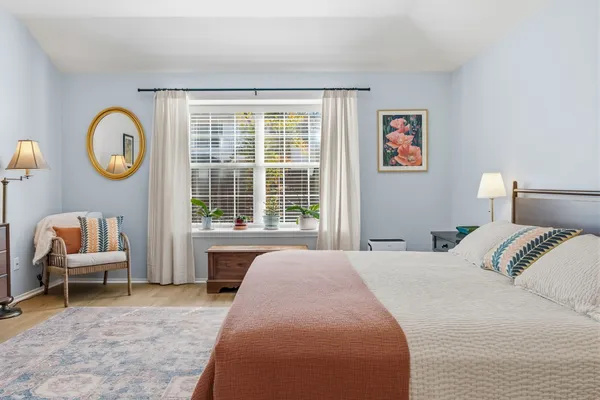 a bedroom with a bed and a chair