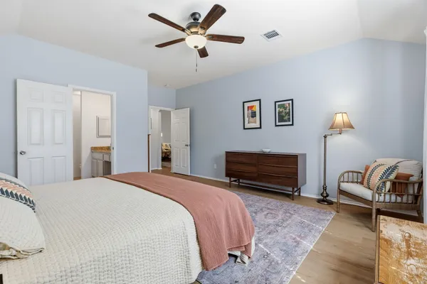 a bedroom with a bed and a couch