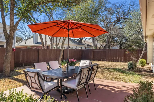 a patio with a table and chairs
