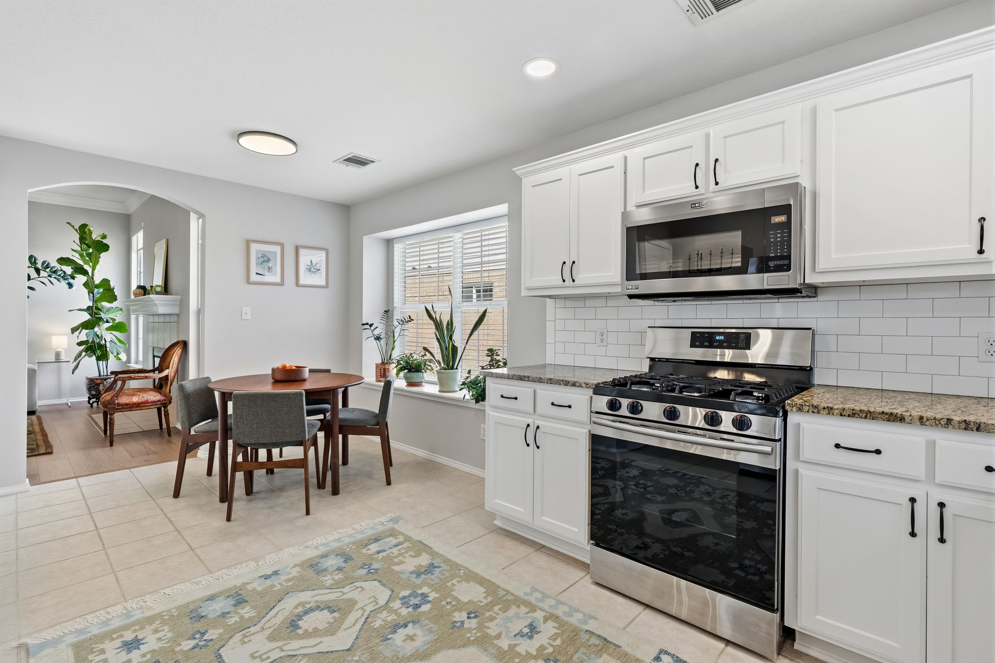 2306 Clover Ridge Drive Cedar Park, TX 78613 - Photo 3 of 29 a kitchen with a stove a sink and a microwave