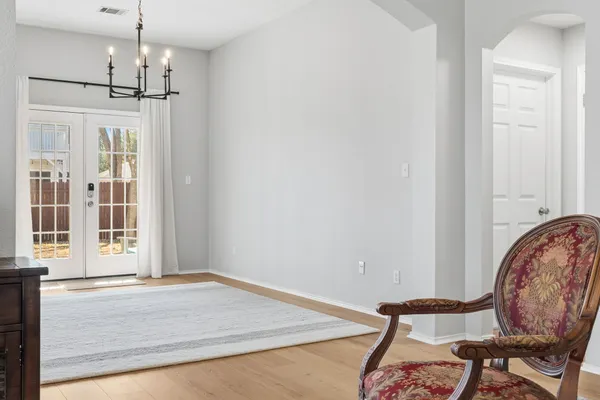 a view of a room with furniture and wooden floor