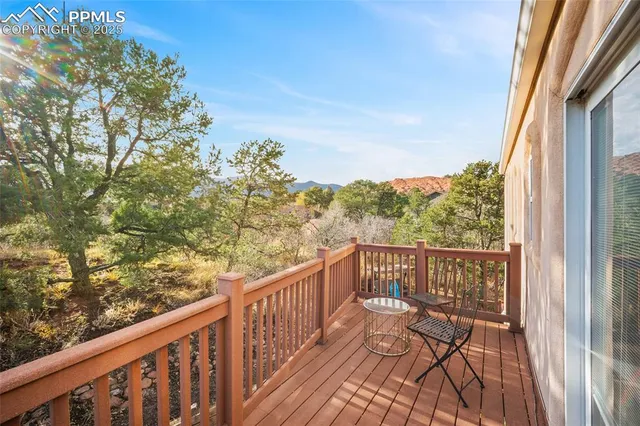 a view of a balcony with wooden floor and fence