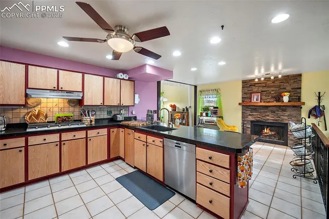 a kitchen with stainless steel appliances granite countertop a sink and cabinets
