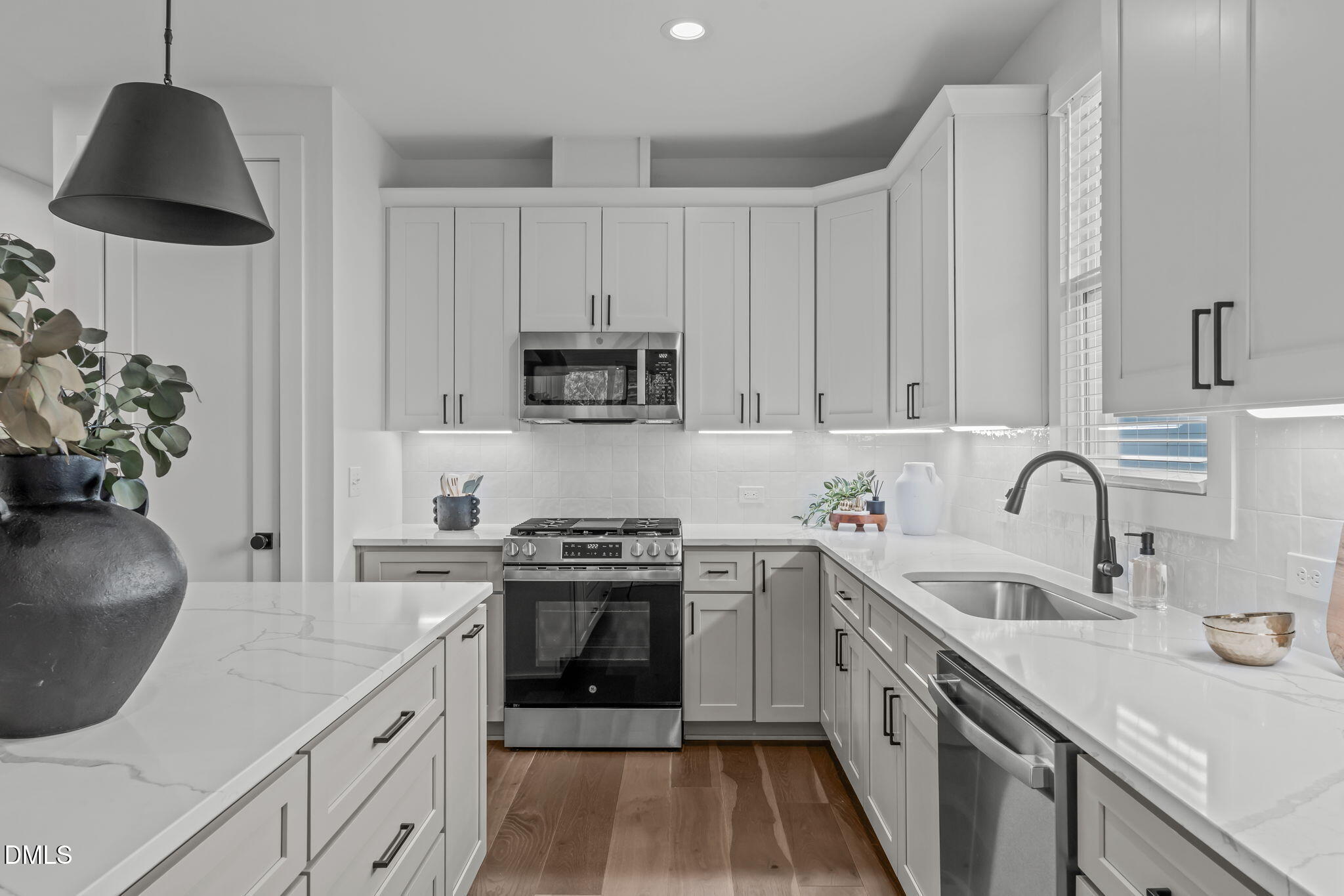 637 Conover Road, Unit A Durham, NC 27703 - Photo 12 of 51 a kitchen with white cabinets a sink a stove and a oven