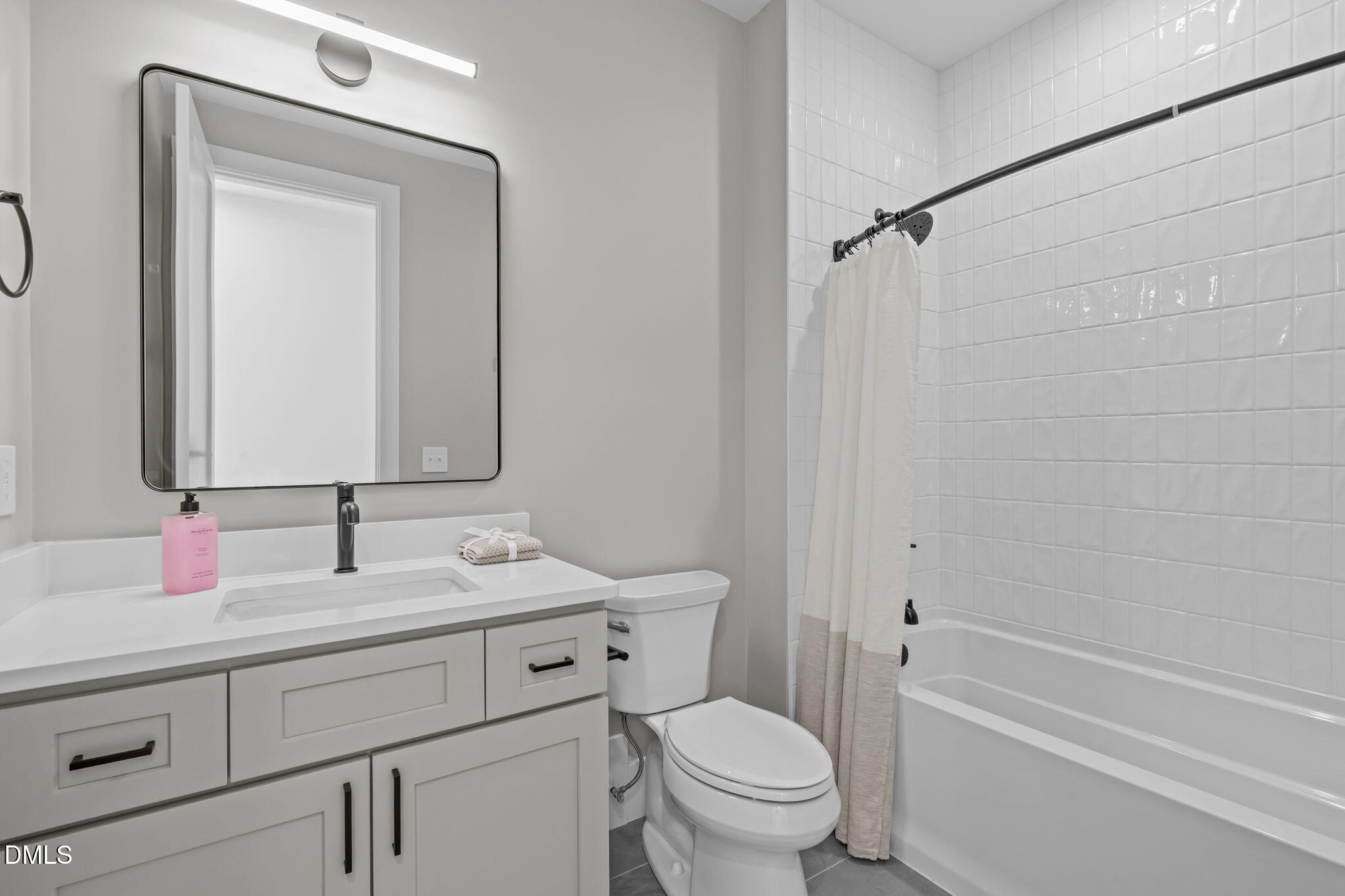 637 Conover Road, Unit A Durham, NC 27703 - Photo 32 of 51 a bathroom with a granite countertop toilet sink and mirror