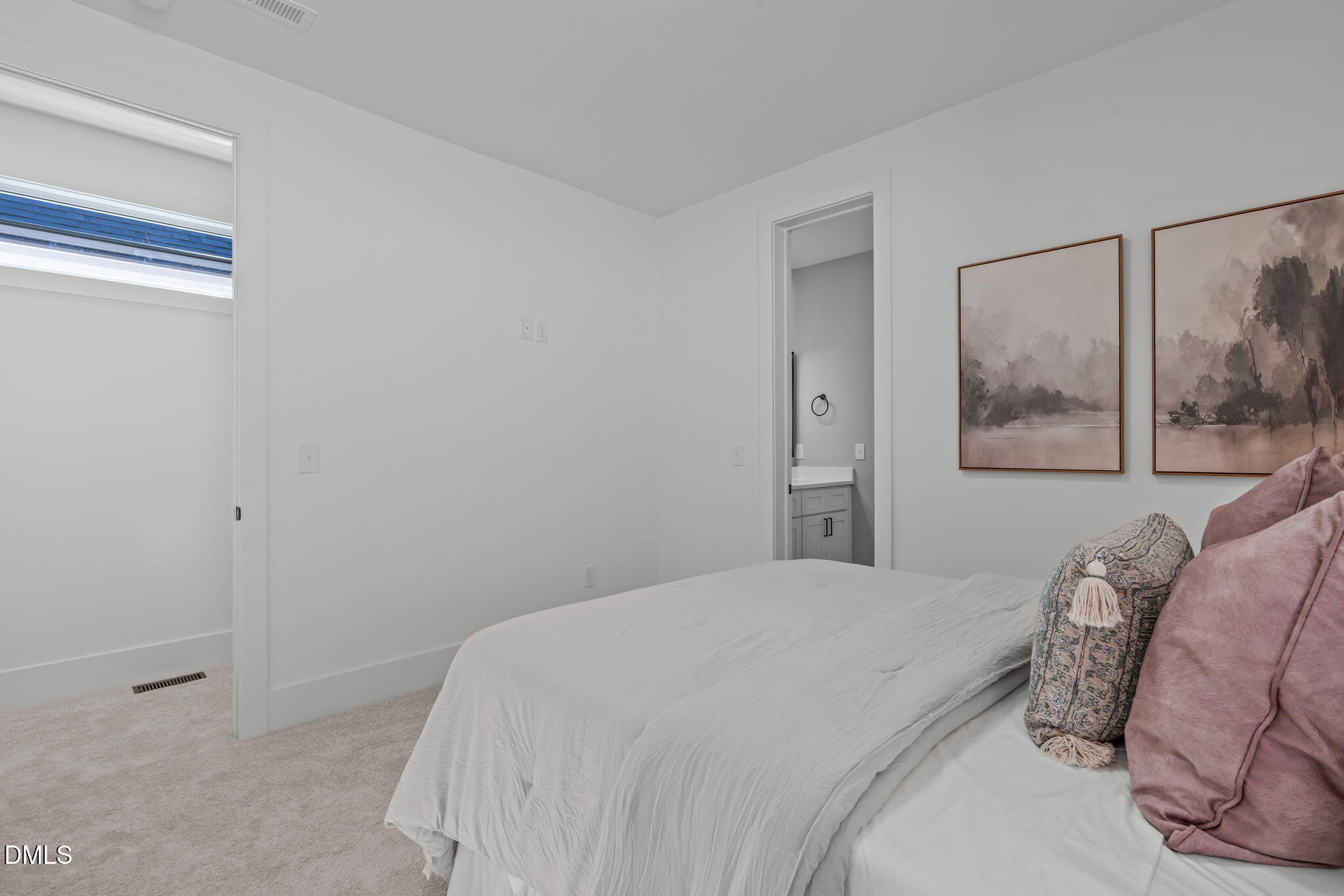 637 Conover Road, Unit A Durham, NC 27703 - Photo 34 of 51 a bedroom with a bed and a painting on the wall