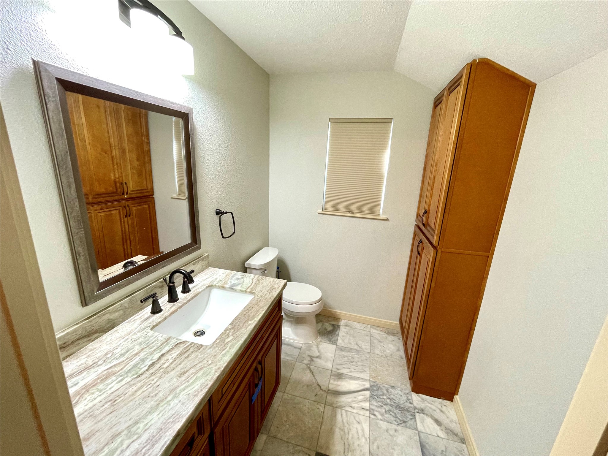 216 Woerner Road Houston, TX 77090 - Photo 27 of 33 a bathroom with a granite countertop sink and a mirror