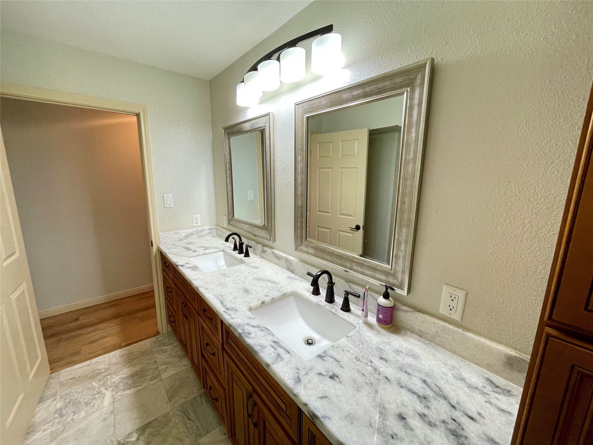 216 Woerner Road Houston, TX 77090 - Photo 31 of 33 a bathroom with a double vanity sink and a mirror