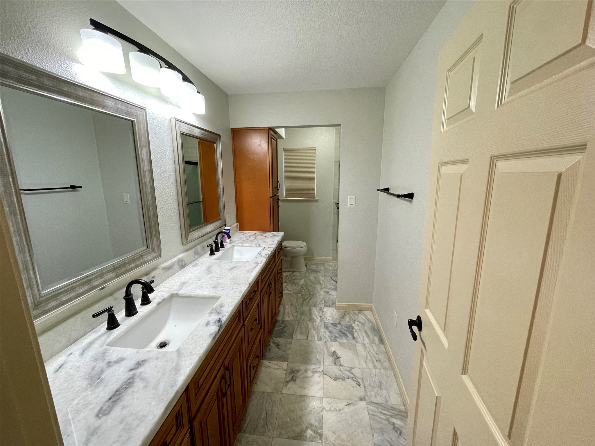 216 Woerner Road Houston, TX 77090 - Photo 32 of 33 a bathroom with a granite countertop sink and a mirror
