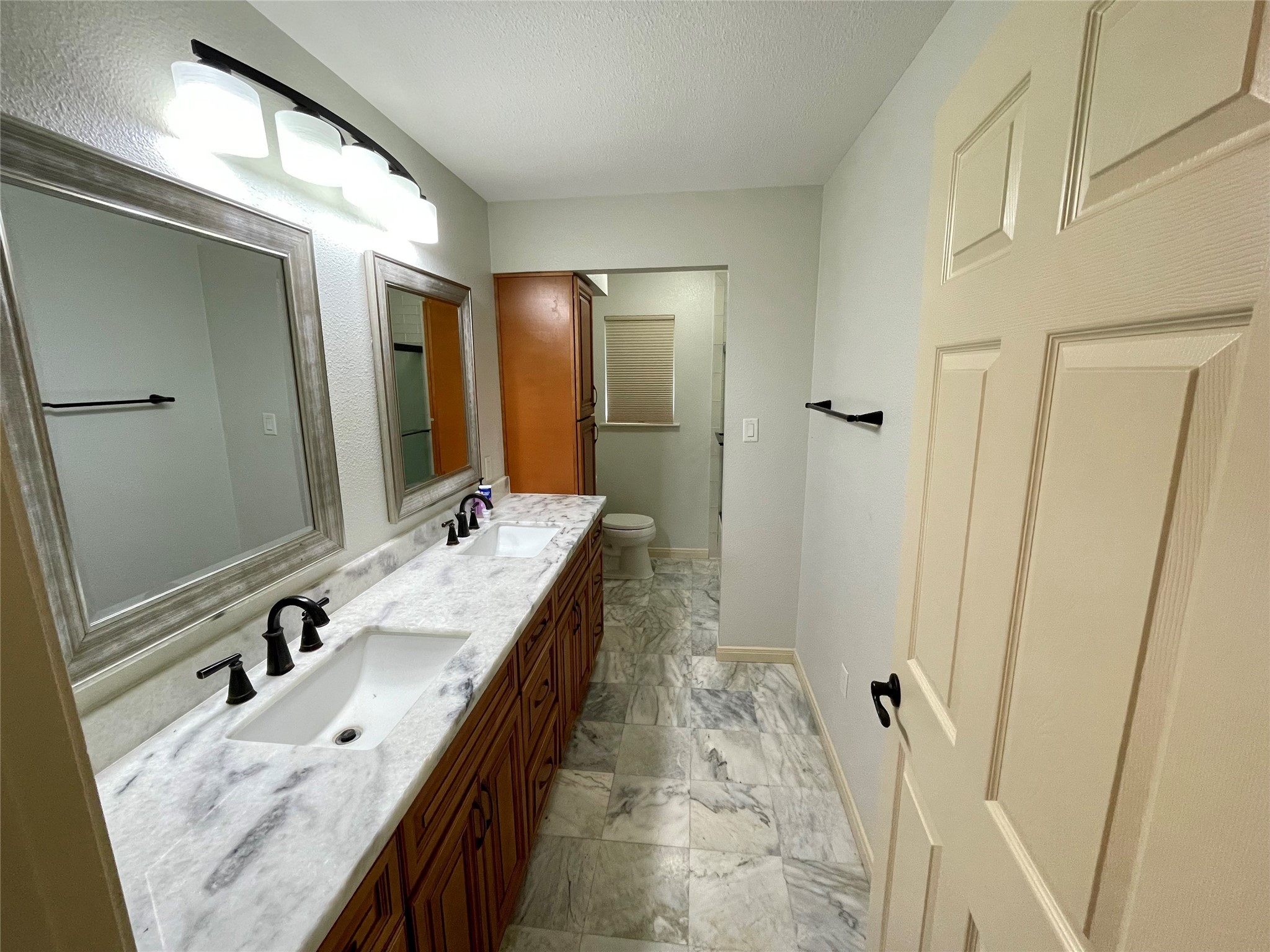 216 Woerner Road Houston, TX 77090 - Photo 32 of 33 a bathroom with a granite countertop sink and a mirror