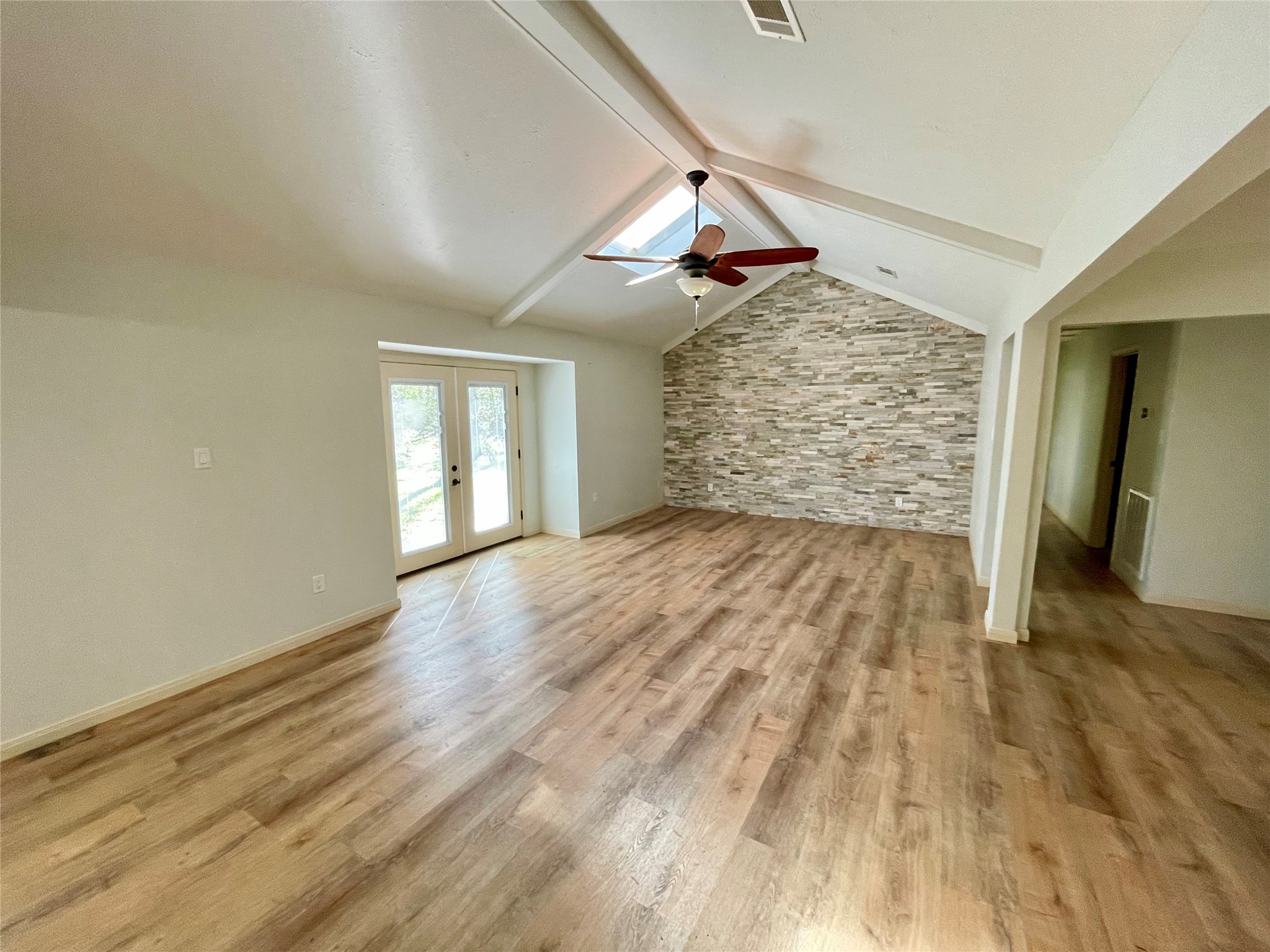 216 Woerner Road Houston, TX 77090 - Photo 6 of 33 a view of an empty room with wooden floor and a window