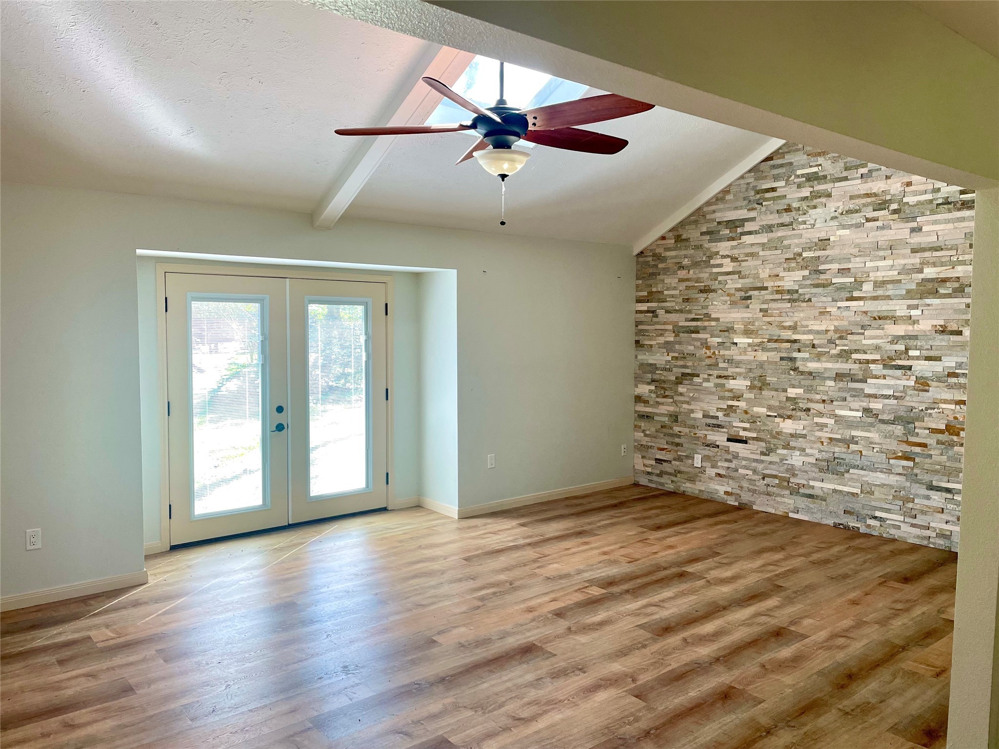 216 Woerner Road Houston, TX 77090 - Photo 9 of 33 an empty room with wooden floor fan and windows