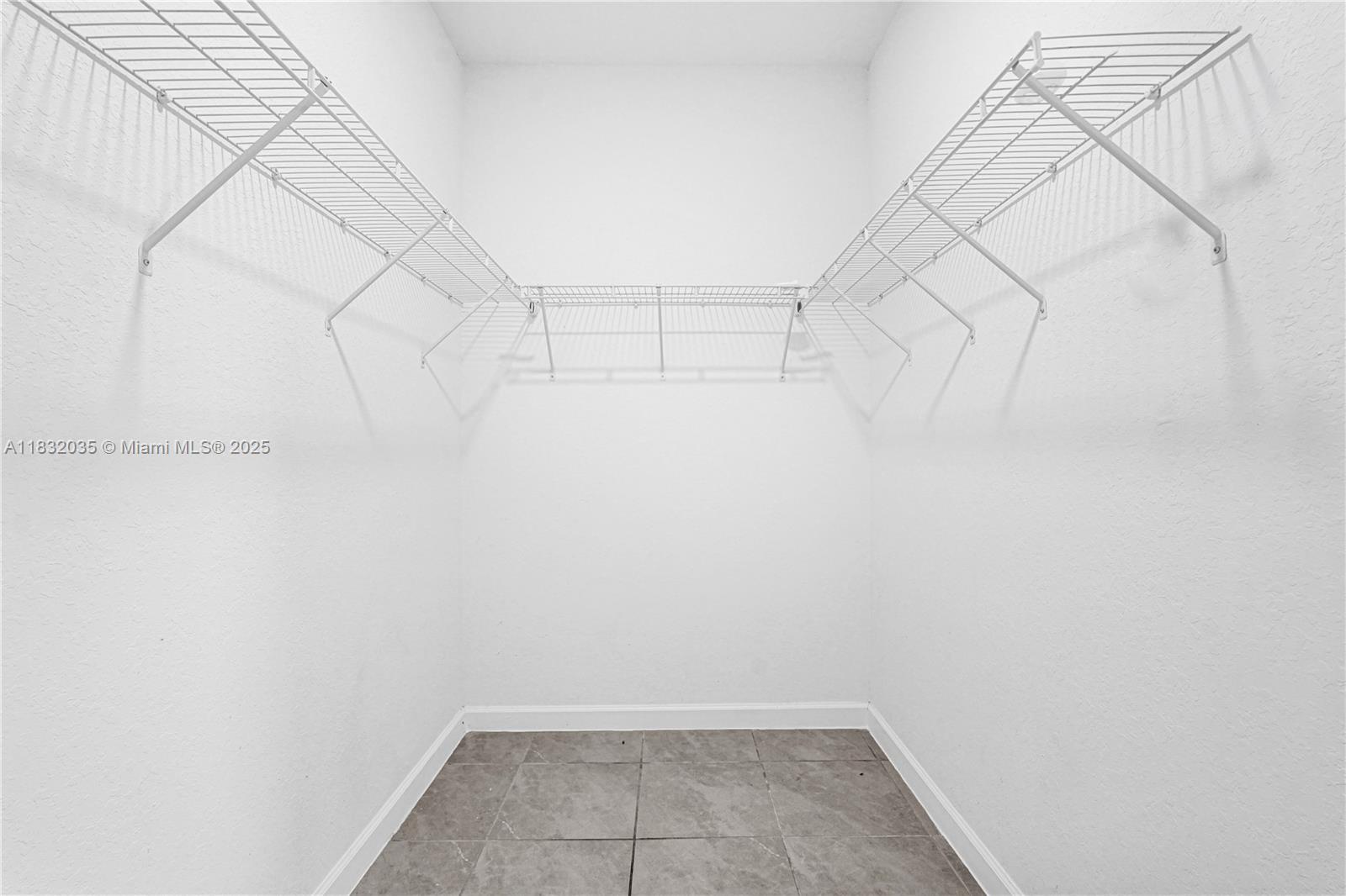 12735 Southwest 211th Street, Unit 12735 Miami, FL 33177 - Photo 11 of 45 a view of a room with racks on the wall