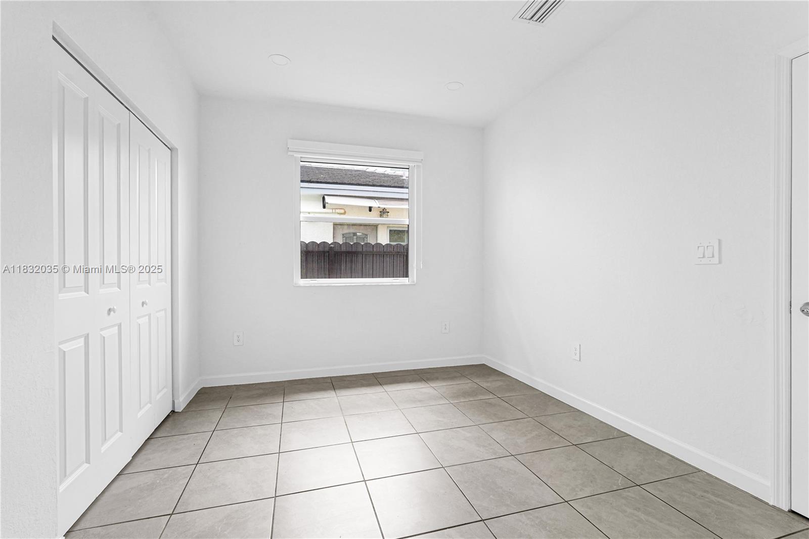 12735 Southwest 211th Street, Unit 12735 Miami, FL 33177 - Photo 13 of 45 a view of an empty room with a window
