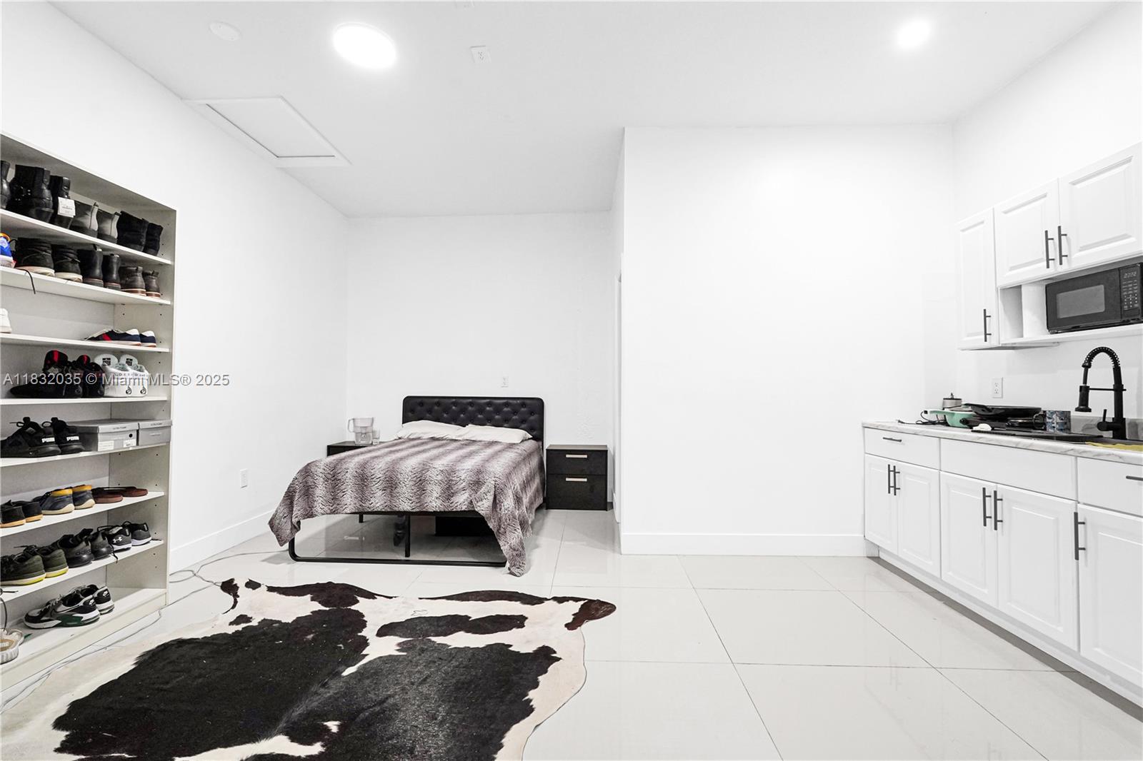 12735 Southwest 211th Street, Unit 12735 Miami, FL 33177 - Photo 17 of 45 a bedroom with a bed and a cabinets