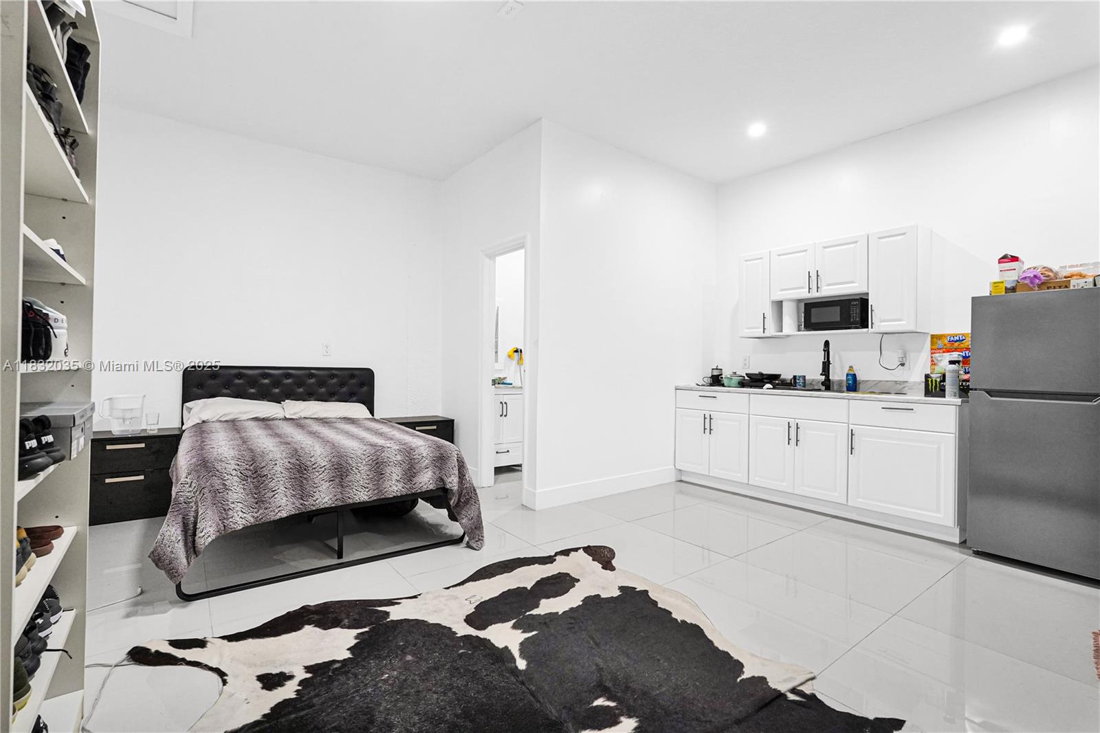 12735 Southwest 211th Street, Unit 12735 Miami, FL 33177 - Photo 23 of 45 a bedroom with a bed and a cabinets