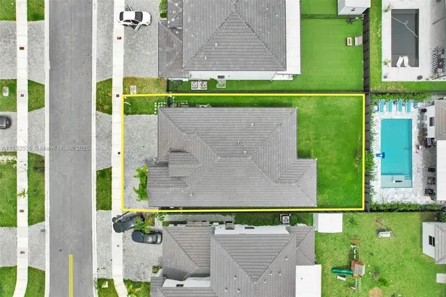 an aerial view of a house with a yard basket ball court and outdoor seating