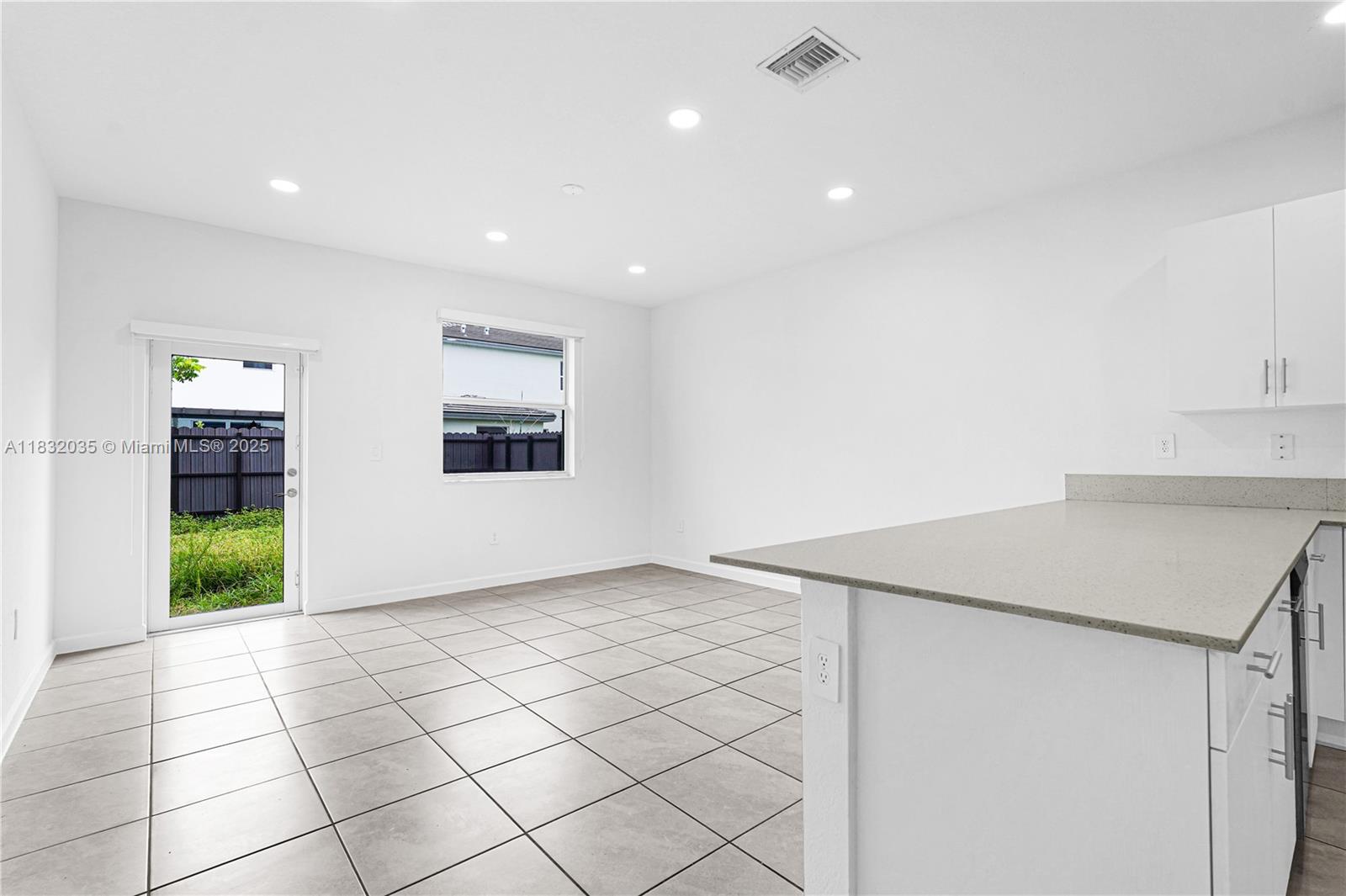 12735 Southwest 211th Street, Unit 12735 Miami, FL 33177 - Photo 34 of 45 a view of an empty room with kitchen and a window