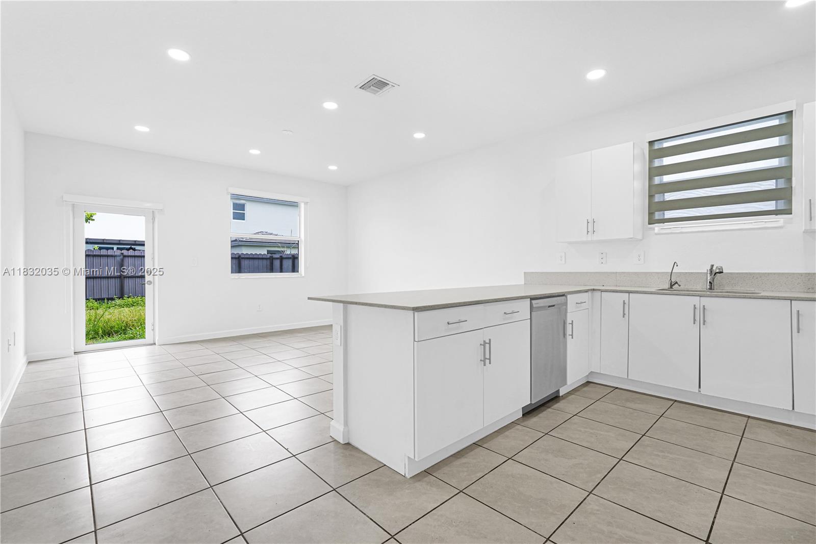 12735 Southwest 211th Street, Unit 12735 Miami, FL 33177 - Photo 44 of 45 a kitchen with a sink a stove cabinets and a window