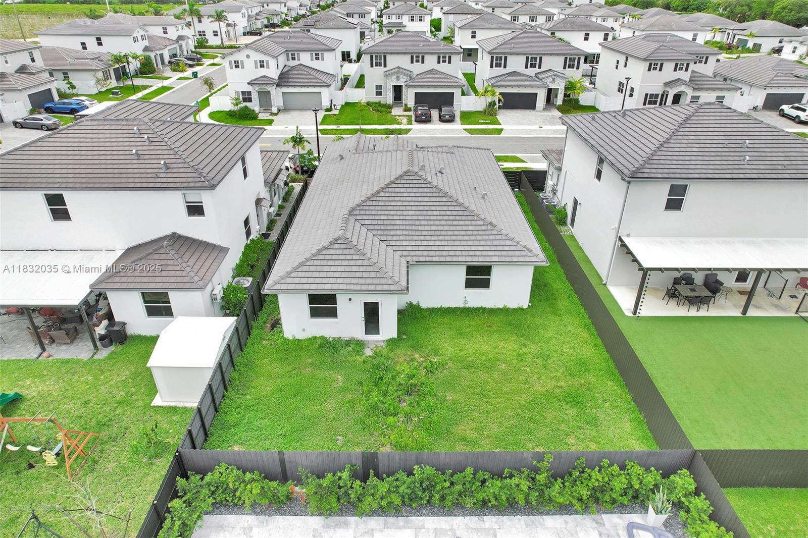 12735 Southwest 211th Street, Unit 12735 Miami, FL 33177 - Photo 5 of 45 a aerial view of a house with a yard table and chairs