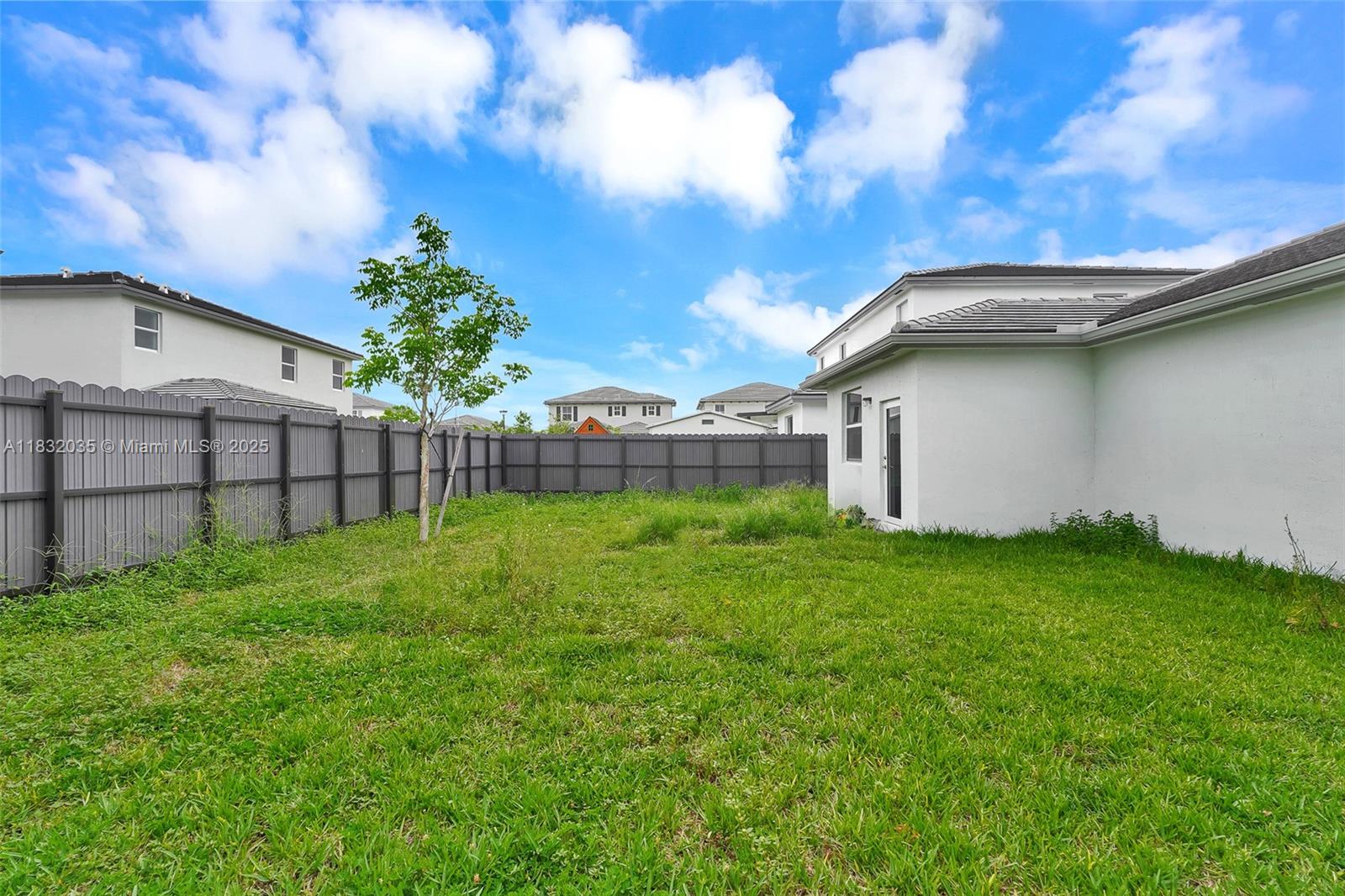 12735 Southwest 211th Street, Unit 12735 Miami, FL 33177 - Photo 7 of 45 a view of a backyard with a garden