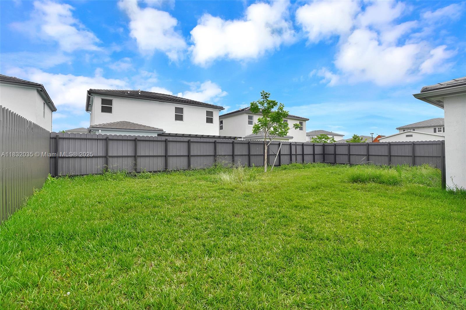 12735 Southwest 211th Street, Unit 12735 Miami, FL 33177 - Photo 8 of 45 a view of a backyard with a garden