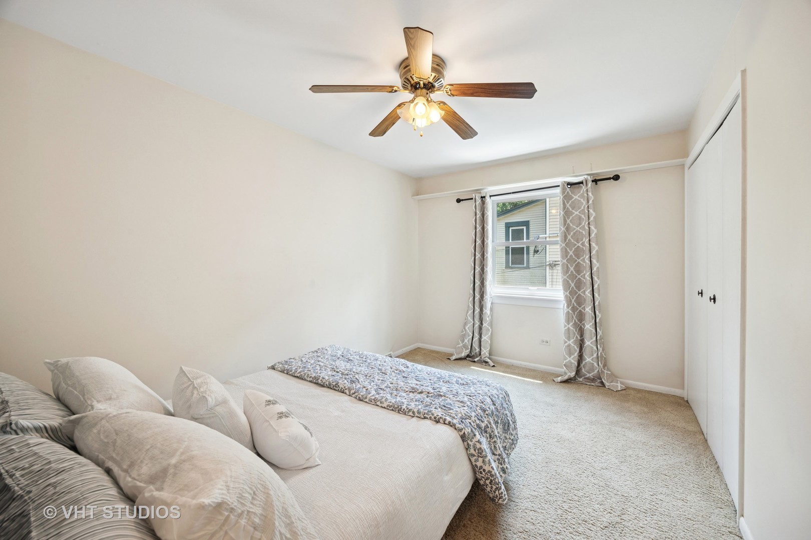 125 Barrypoint Road Riverside, IL 60546 - Photo 17 of 30 a bedroom with a large bed and a ceiling fan