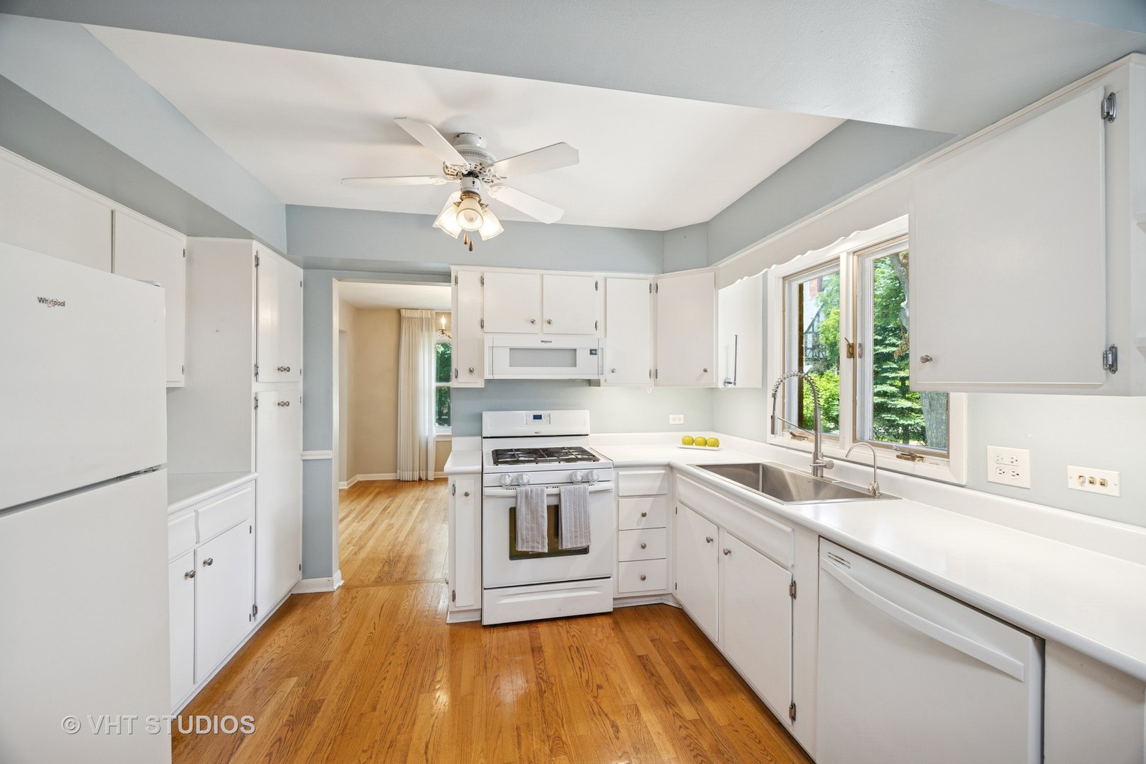 125 Barrypoint Road Riverside, IL 60546 - Photo 3 of 30 a kitchen with stainless steel appliances a stove a sink dishwasher a refrigerator white cabinets and wooden floor