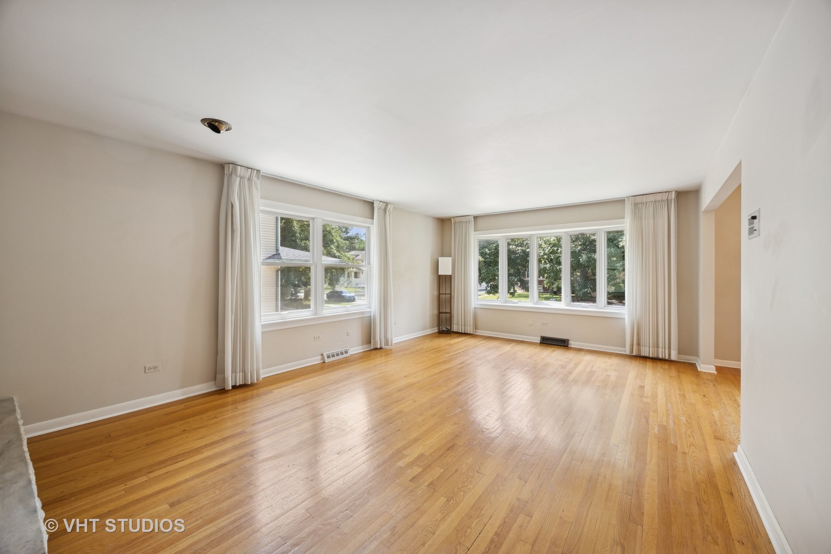 125 Barrypoint Road Riverside, IL 60546 - Photo 7 of 30 a view of an empty room with wooden floor and a window