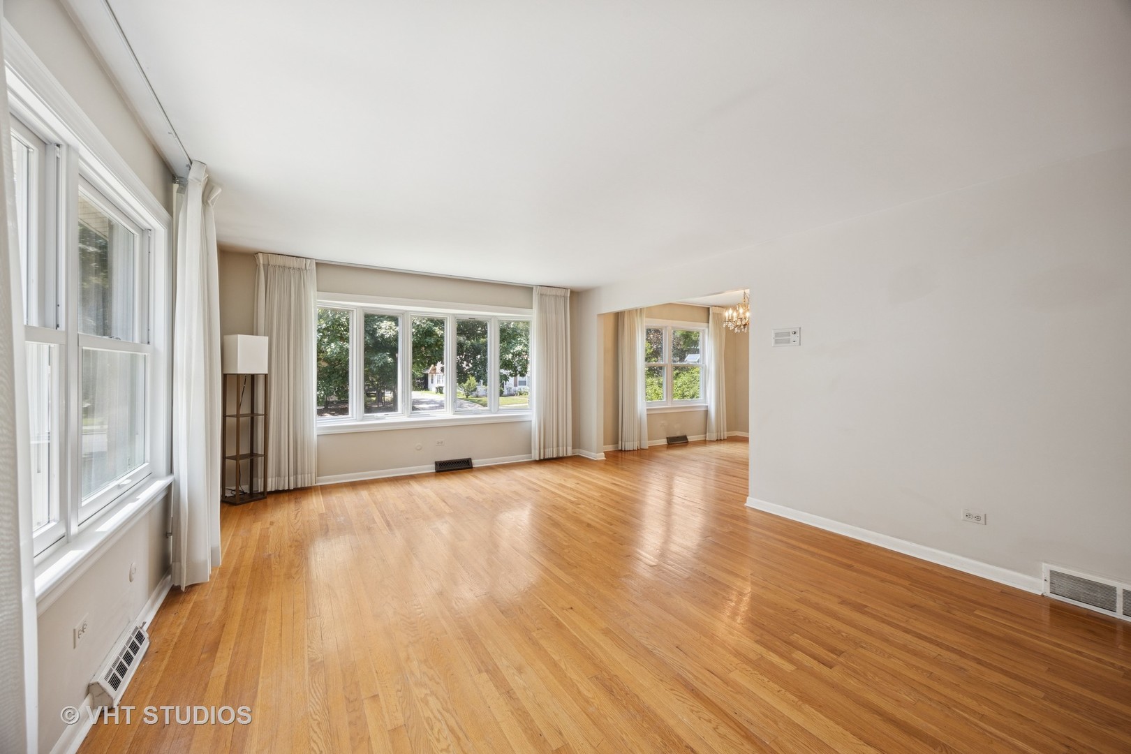 125 Barrypoint Road Riverside, IL 60546 - Photo 8 of 30 a view of an empty room with wooden floor and a window