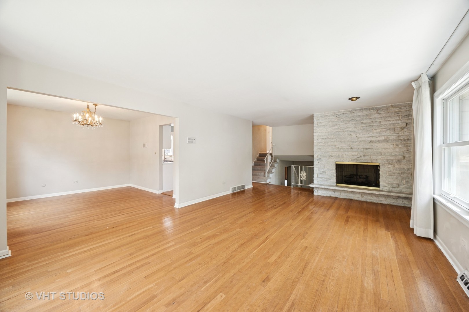 125 Barrypoint Road Riverside, IL 60546 - Photo 10 of 30 a view of empty room with wooden floor and fireplace