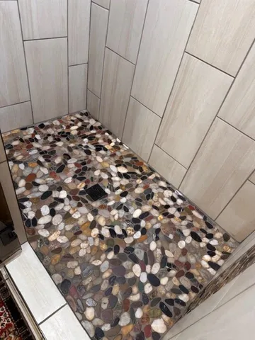 a bathroom with a toilet and a shower