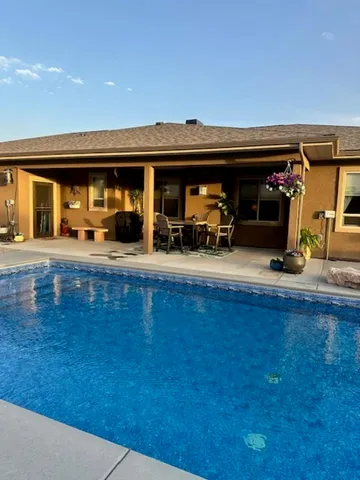 a bedroom with a bed dresser and a chandelier
