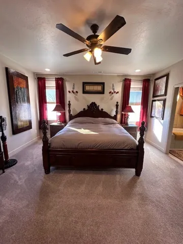 a bedroom with a bed window and a flat screen tv