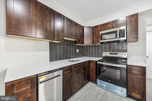 a kitchen with stainless steel appliances granite countertop a sink stove and oven