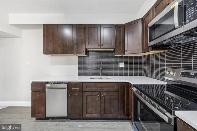 a kitchen with a sink and cabinets