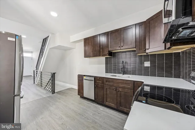 a kitchen with wooden cabinets and a sink