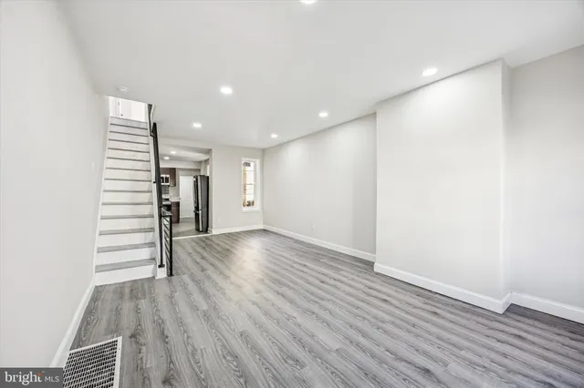 a view of empty room with wooden floor