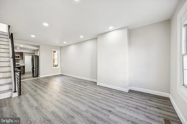 a view of an empty room with wooden floor