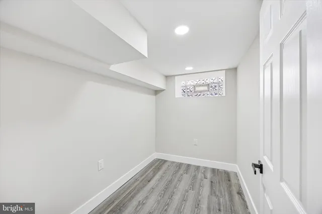 a view of a room with wooden floor