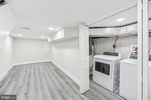 a view of a kitchen with a sink and wooden floor