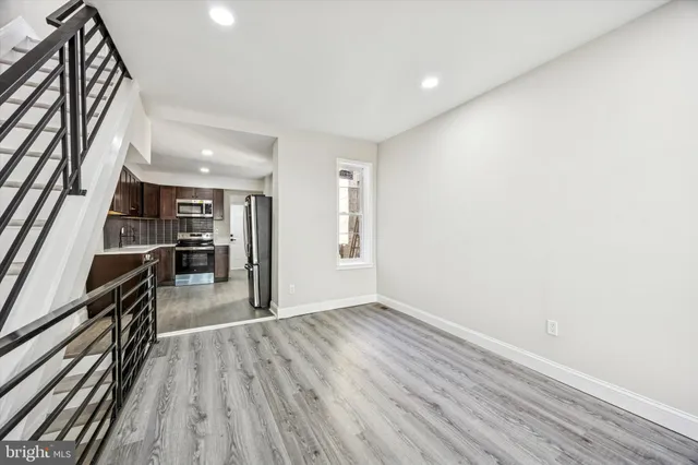 a view of a hallway with wooden floor